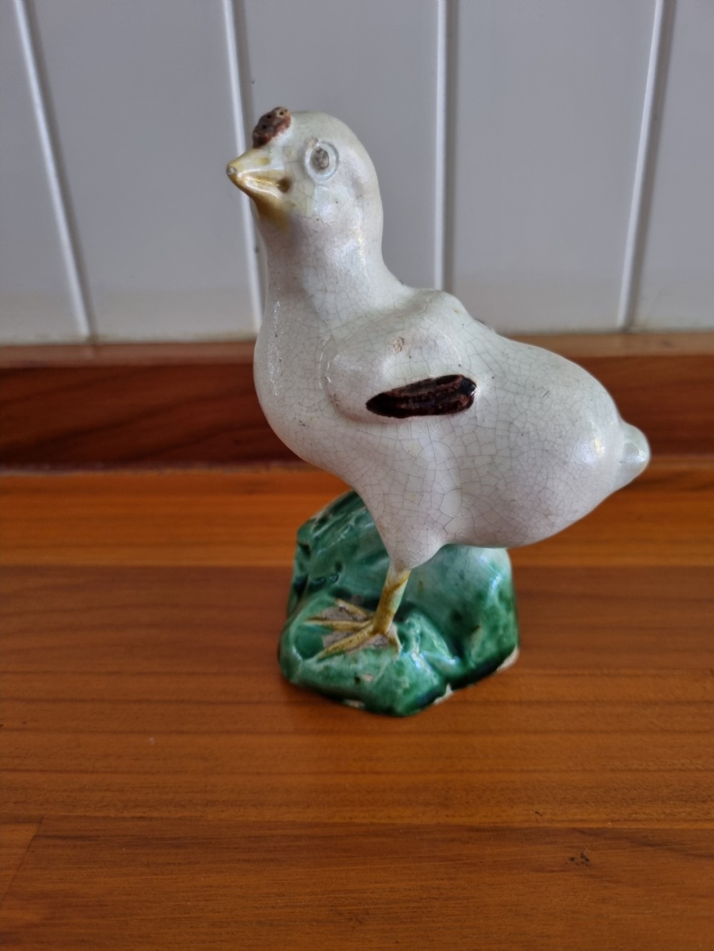A late 18th-century Prattware glazed ceramic figure of a chicken standing on a textured green base. View VIII