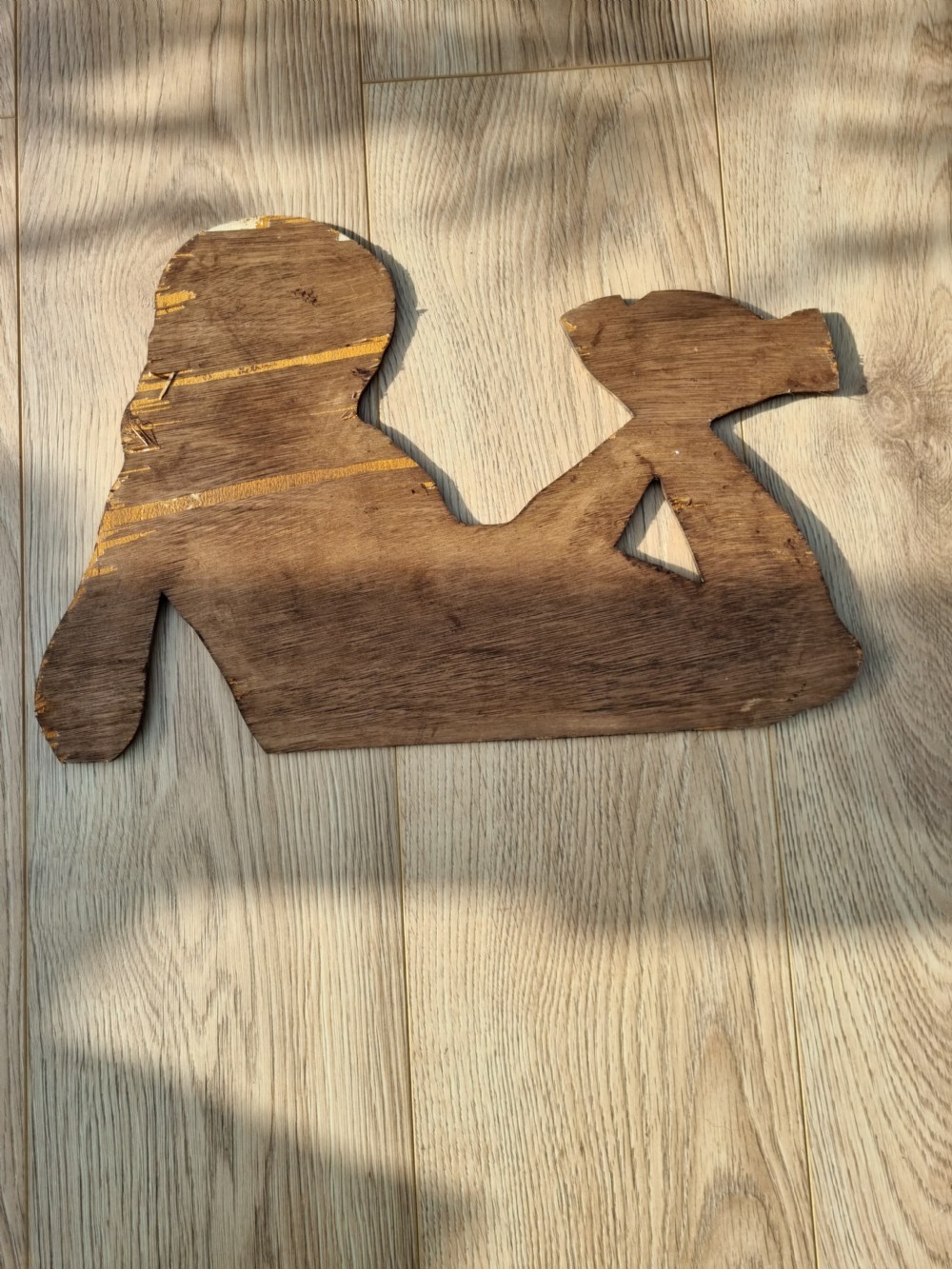 A vintage cardboard counter display sign shaped as a lying boy advertising Dinky Toys. View VI