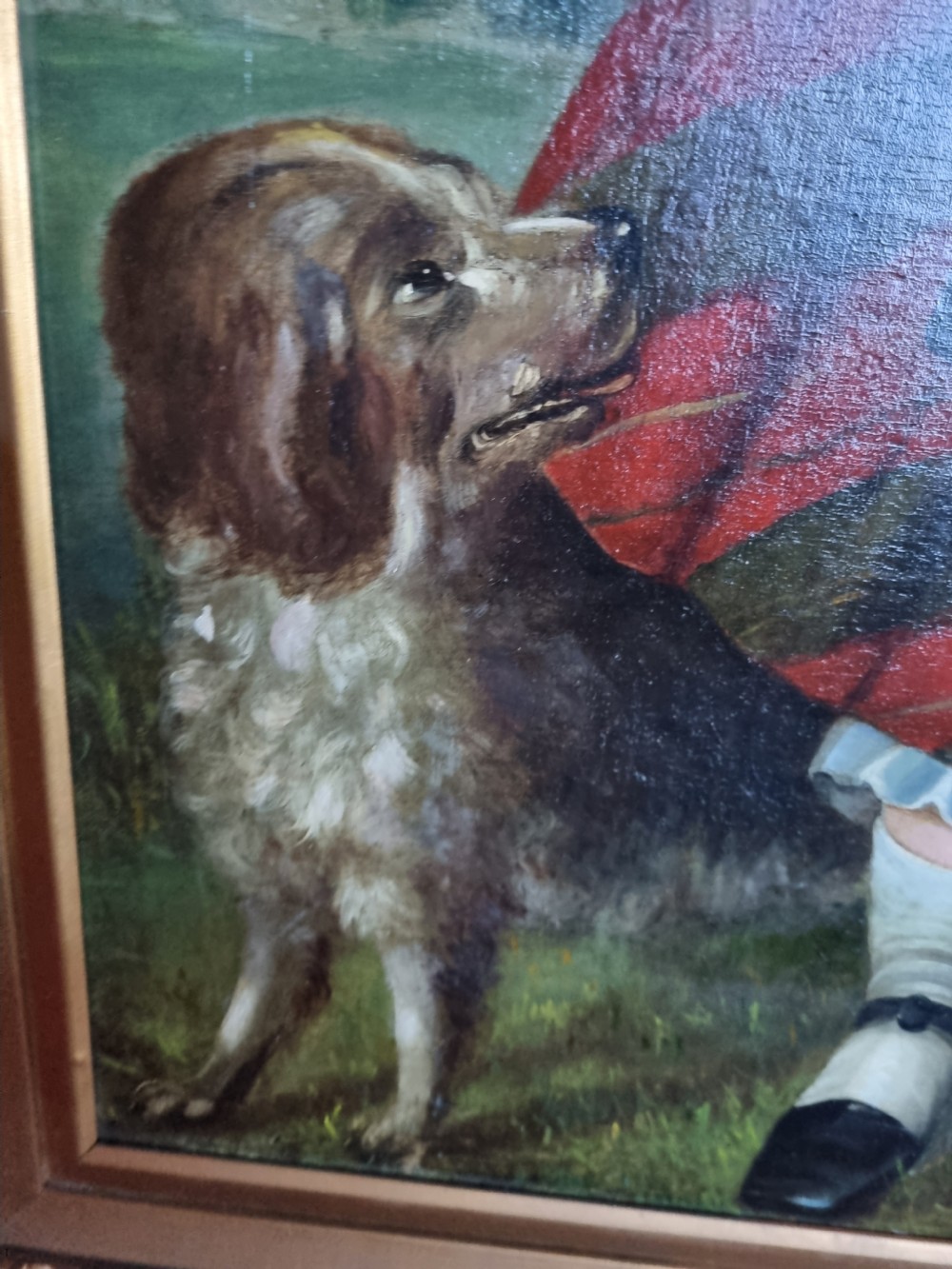A 19th-century naive oil painting on canvas depicting a standing child in a red and dark blue striped dress with a dog, displayed within a gilded frame. View III