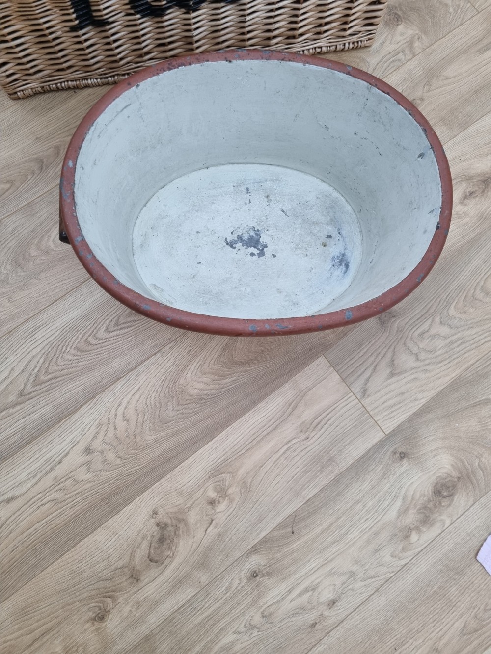 An oval nineteenth-century metal footbath featuring a hand-painted scumbled faux-wood effect, a terracotta rolled rim, and heavy side carrying handles. View IV