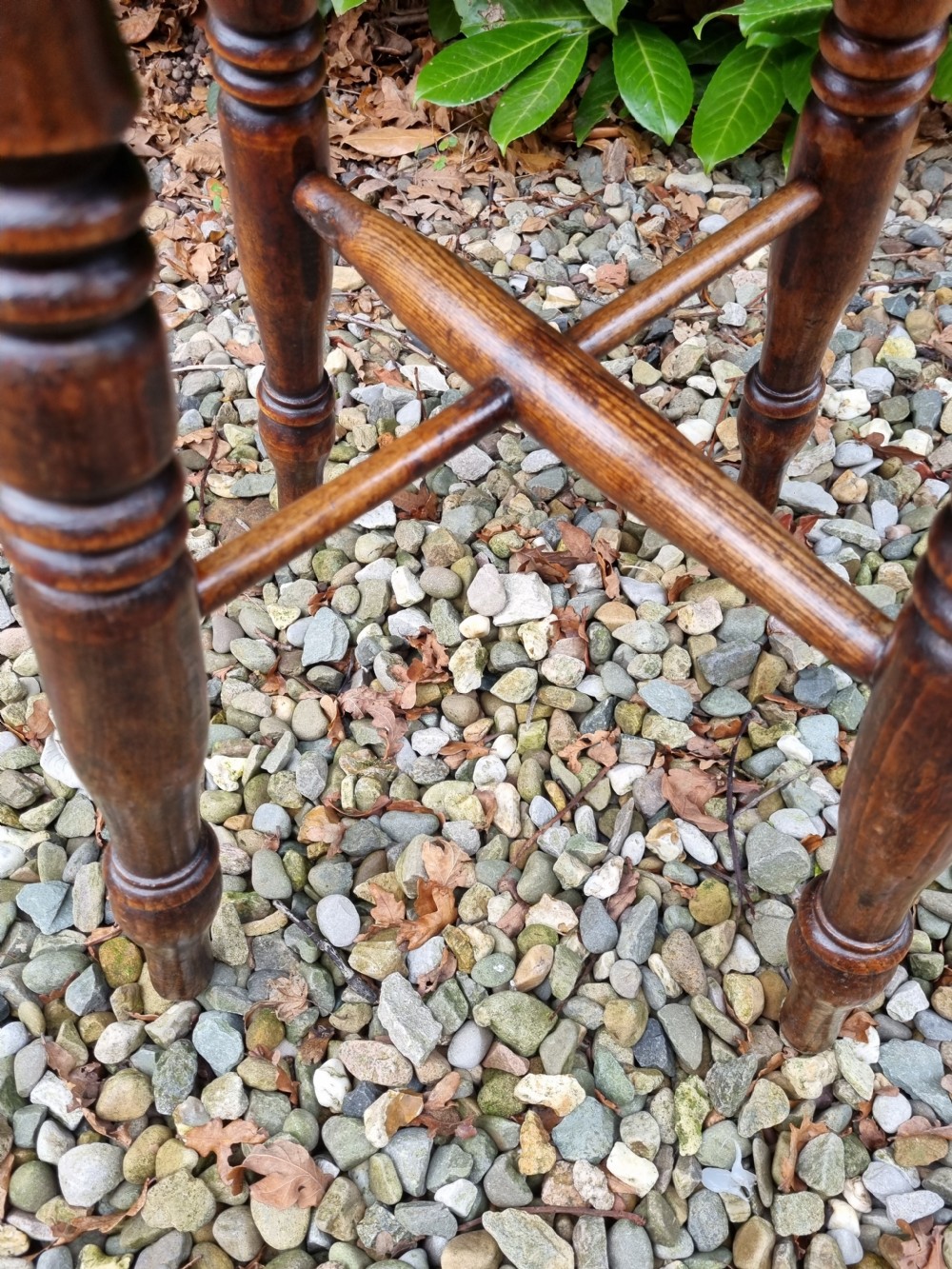 A 19th-century tall wooden stool crafted from elm, featuring a circular seat, four turned legs, and cross stretchers. View IV