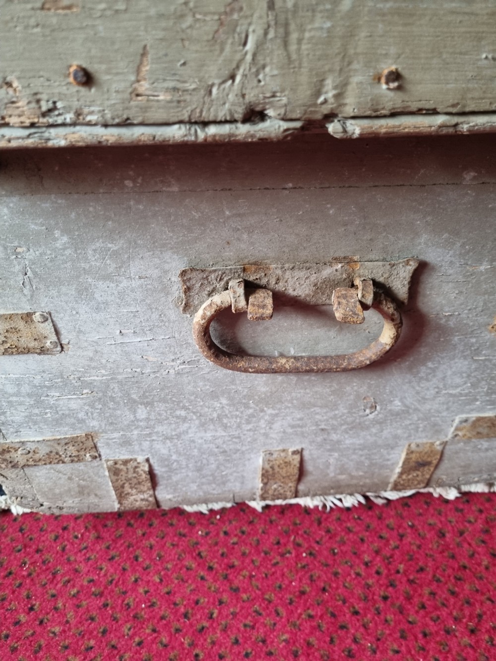 A 19th-century rectangular pine storage chest featuring weathered grey paint, iron corner bracing, metal side handles, and a flat hinged lid. View III