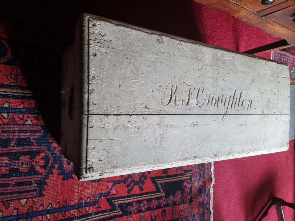 A 19th-century rectangular pine storage chest featuring weathered grey paint, iron corner bracing, metal side handles, and a flat hinged lid. View IV