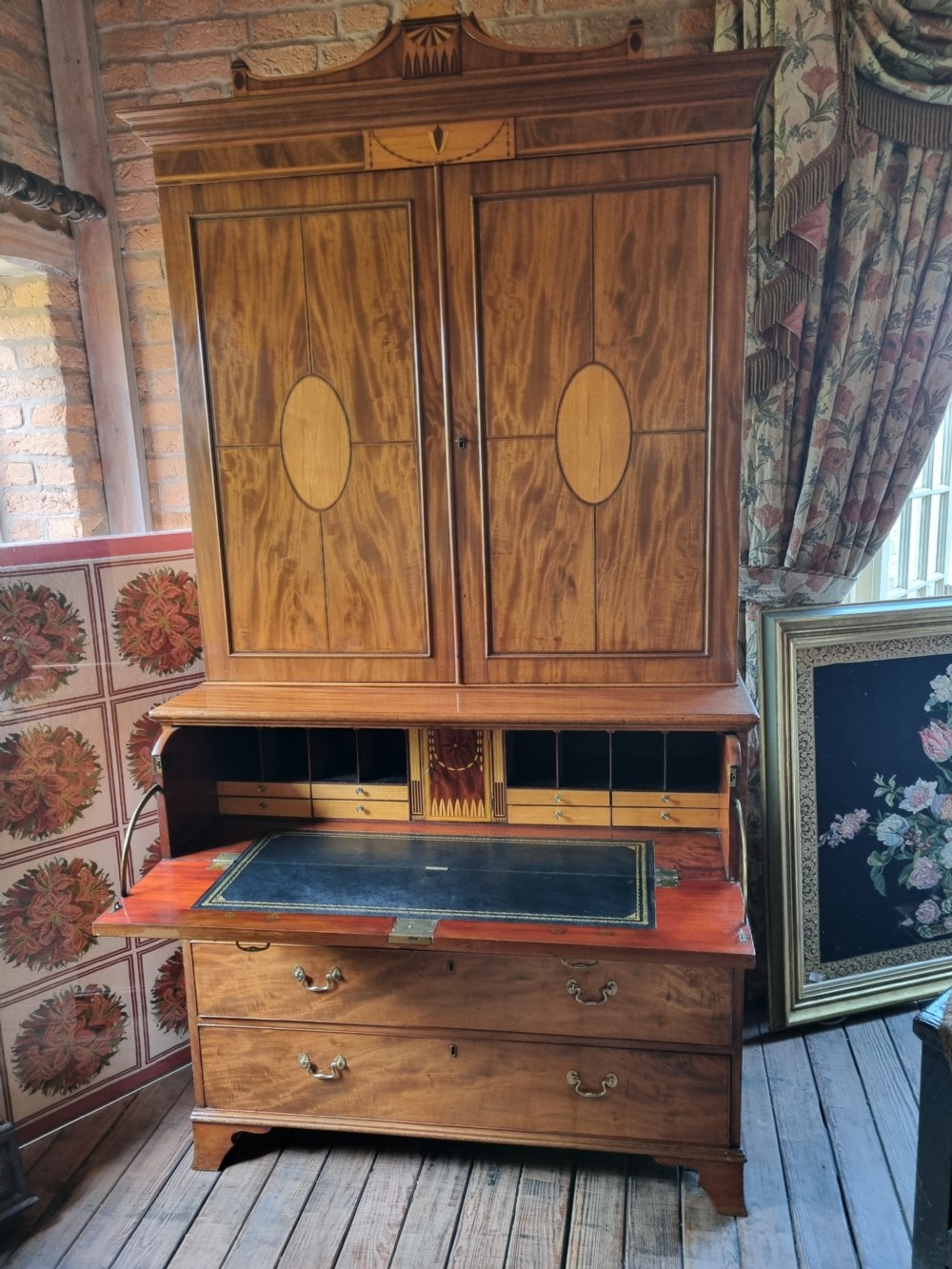 A late 18th-century mahogany secretaire cabinet featuring satinwood oval inlays on the doors, a pull-out writing drawer, and lower drawers with brass swan-neck handles. View II