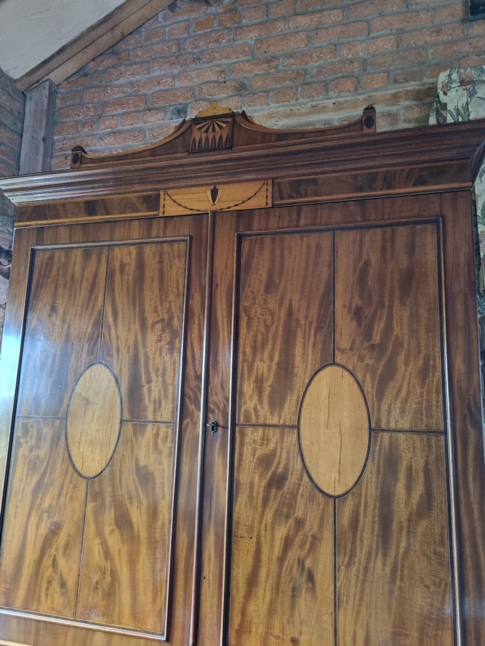A late 18th-century mahogany secretaire cabinet featuring satinwood oval inlays on the doors, a pull-out writing drawer, and lower drawers with brass swan-neck handles. View V