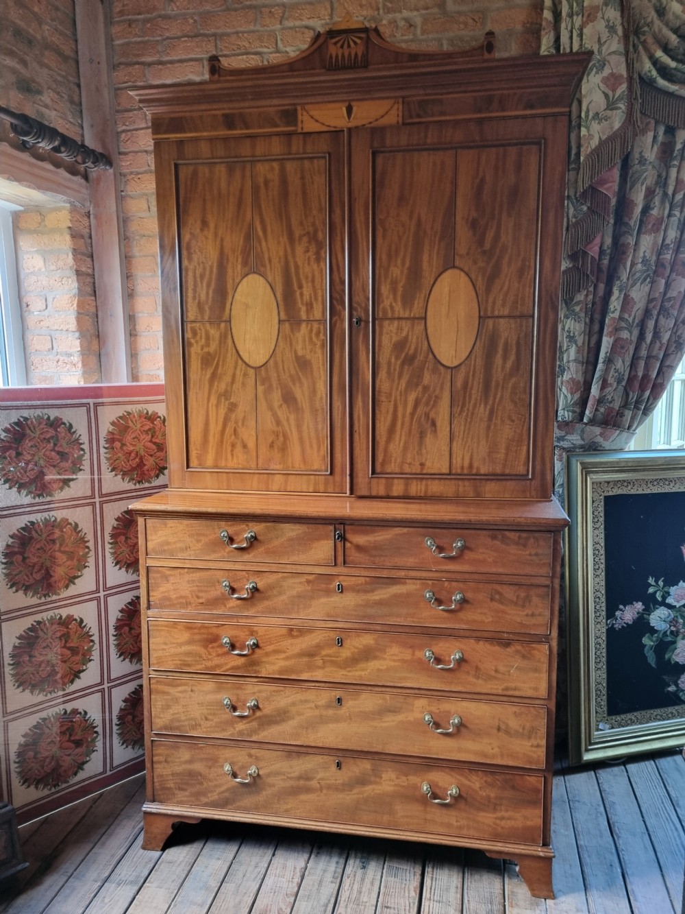 A late 18th-century mahogany secretaire cabinet featuring satinwood oval inlays on the doors, a pull-out writing drawer, and lower drawers with brass swan-neck handles. View VII