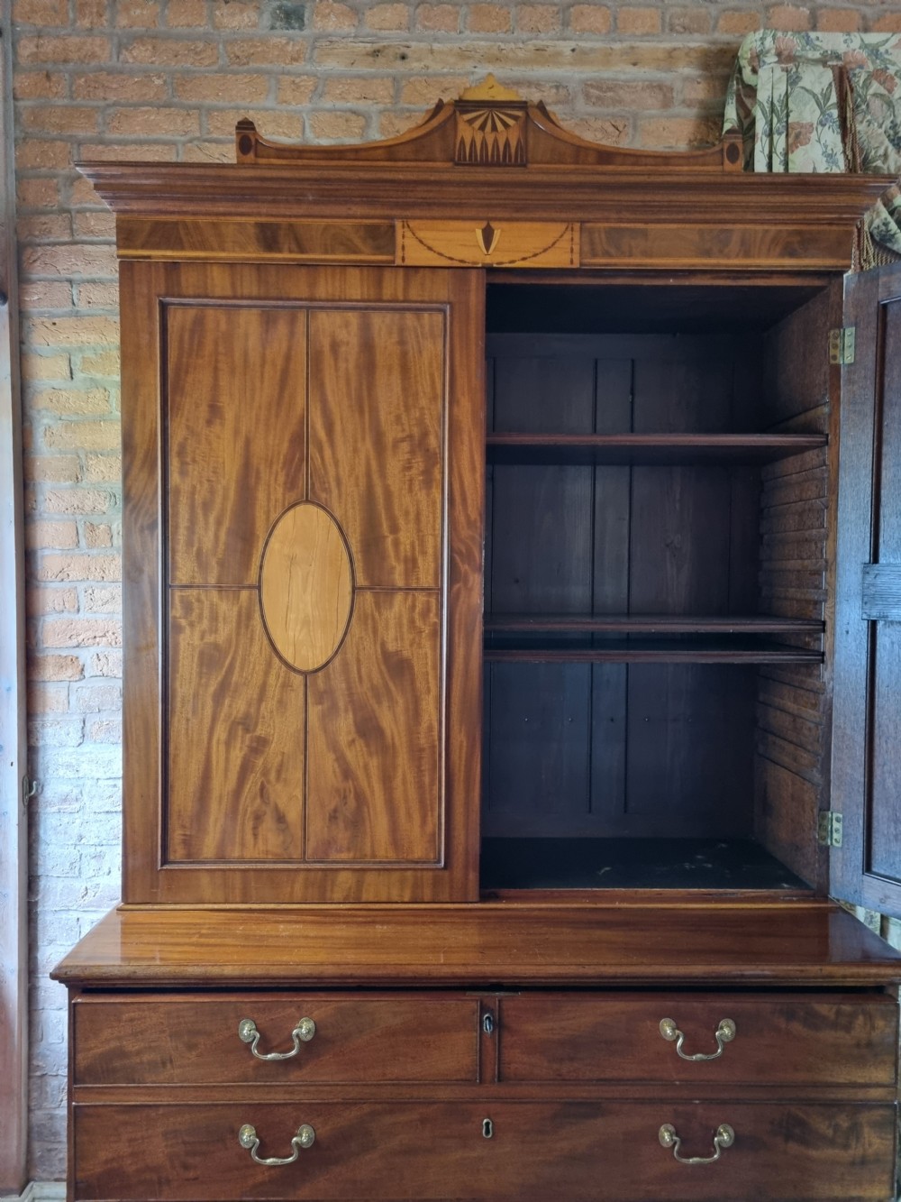 A late 18th-century mahogany secretaire cabinet featuring satinwood oval inlays on the doors, a pull-out writing drawer, and lower drawers with brass swan-neck handles. View X