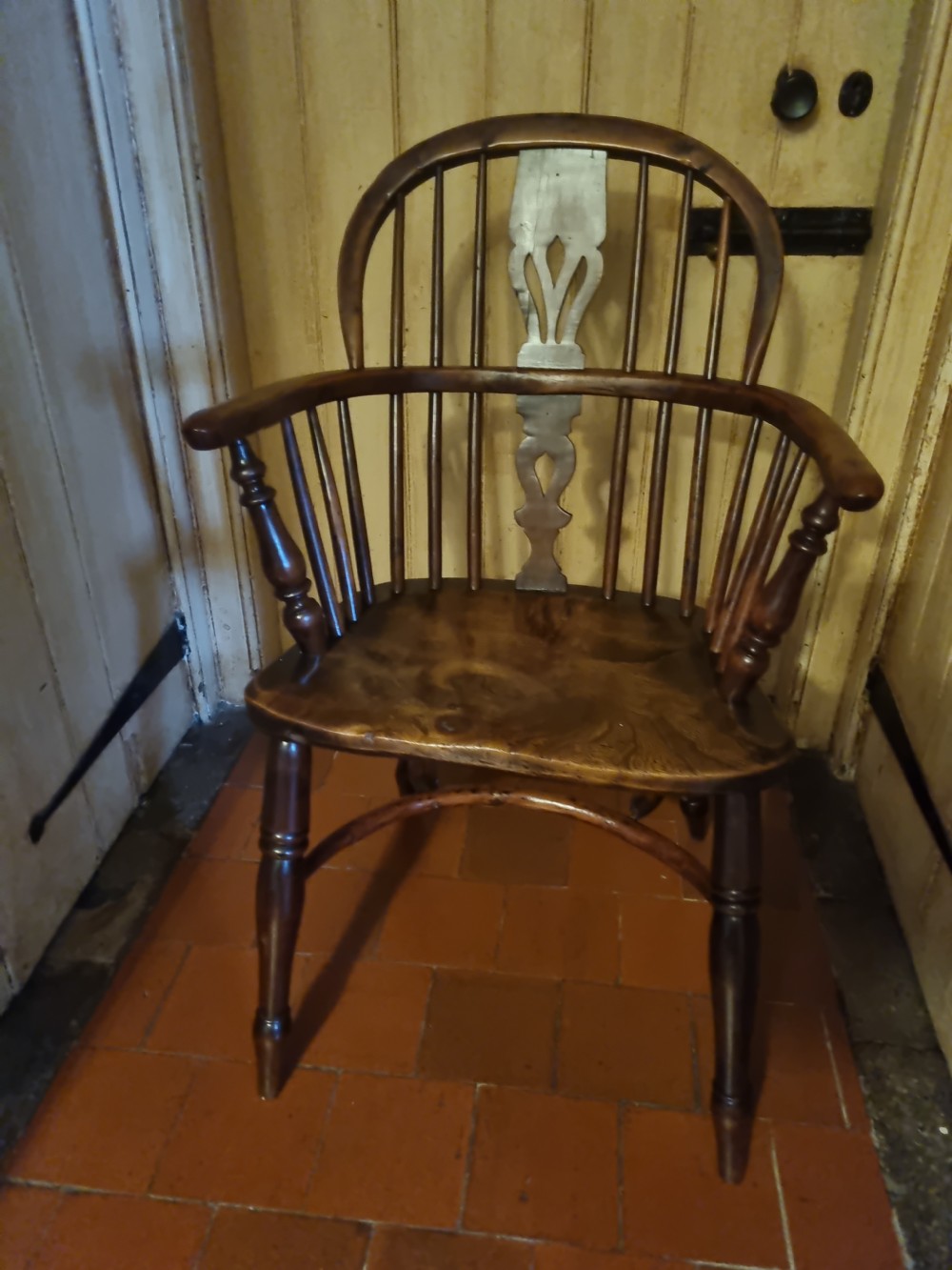 A 19th-century yew wood Windsor armchair with a hoop back, central pierced splat, turned legs, and a curved stretcher. View III