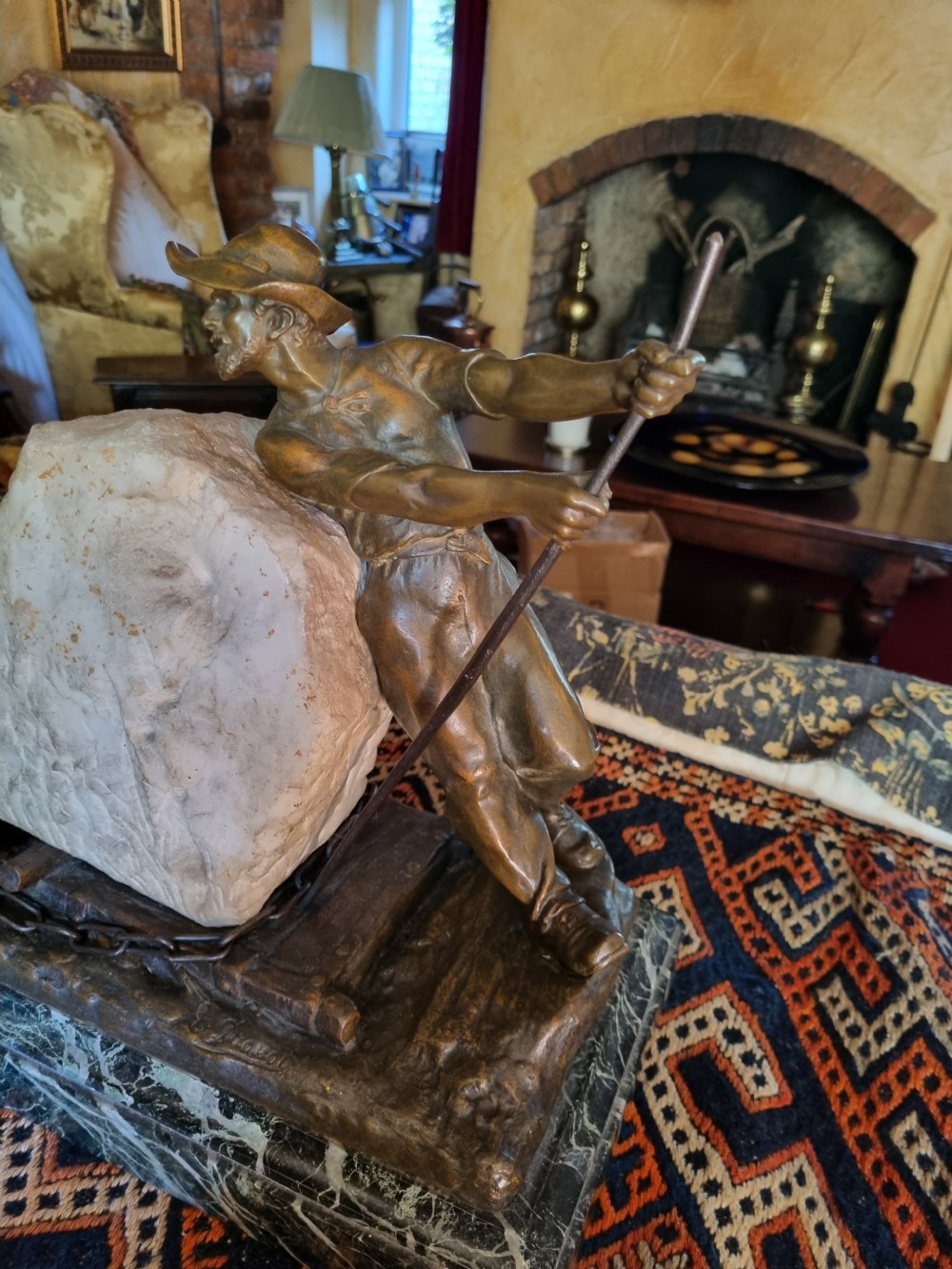 A late 19th-century patinated bronze sculpture depicting a harnessed horse pulling a stone quarry sled alongside a worker, mounted on a green marble base. View III