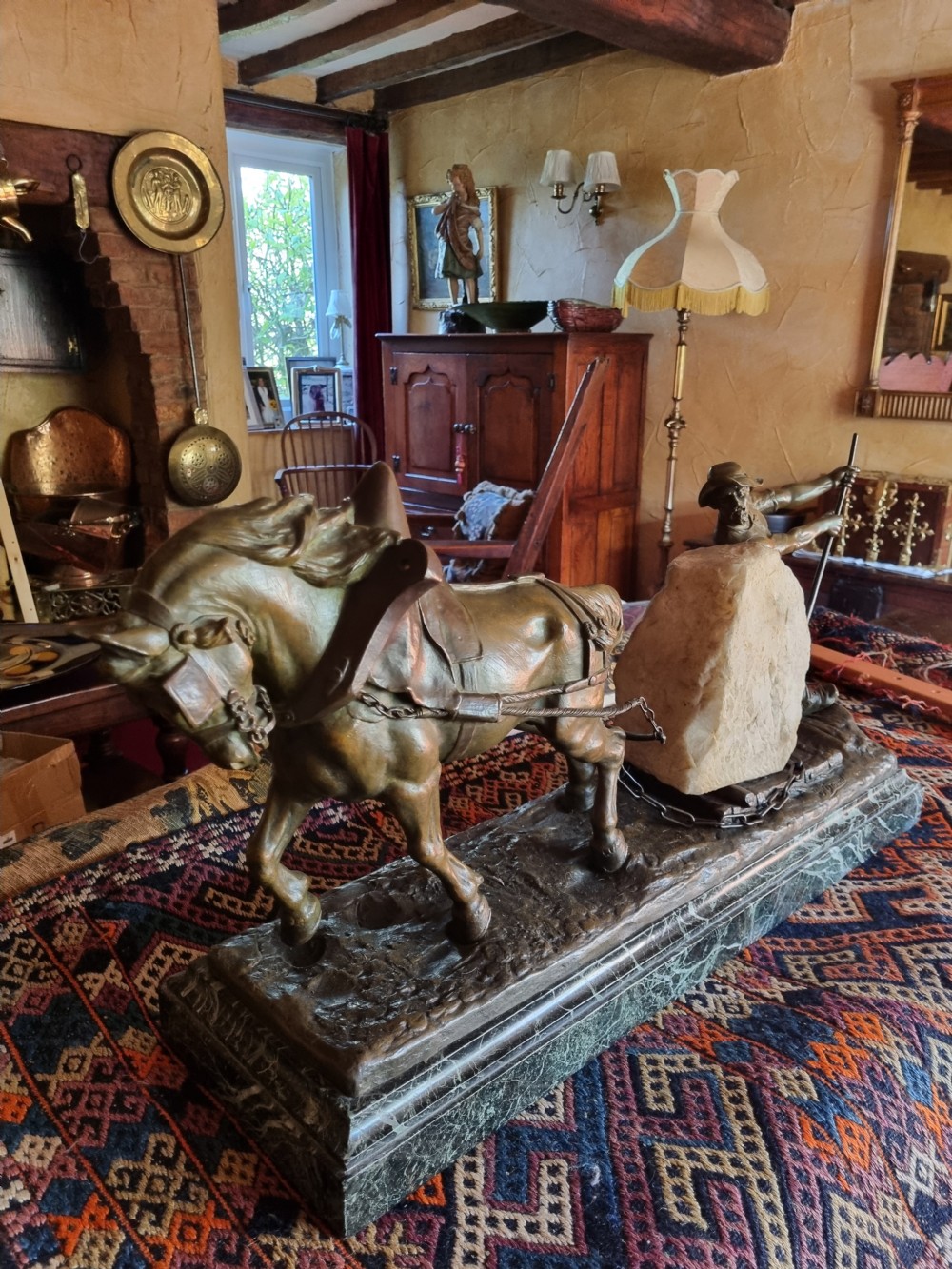 A late 19th-century patinated bronze sculpture depicting a harnessed horse pulling a stone quarry sled alongside a worker, mounted on a green marble base. View VI