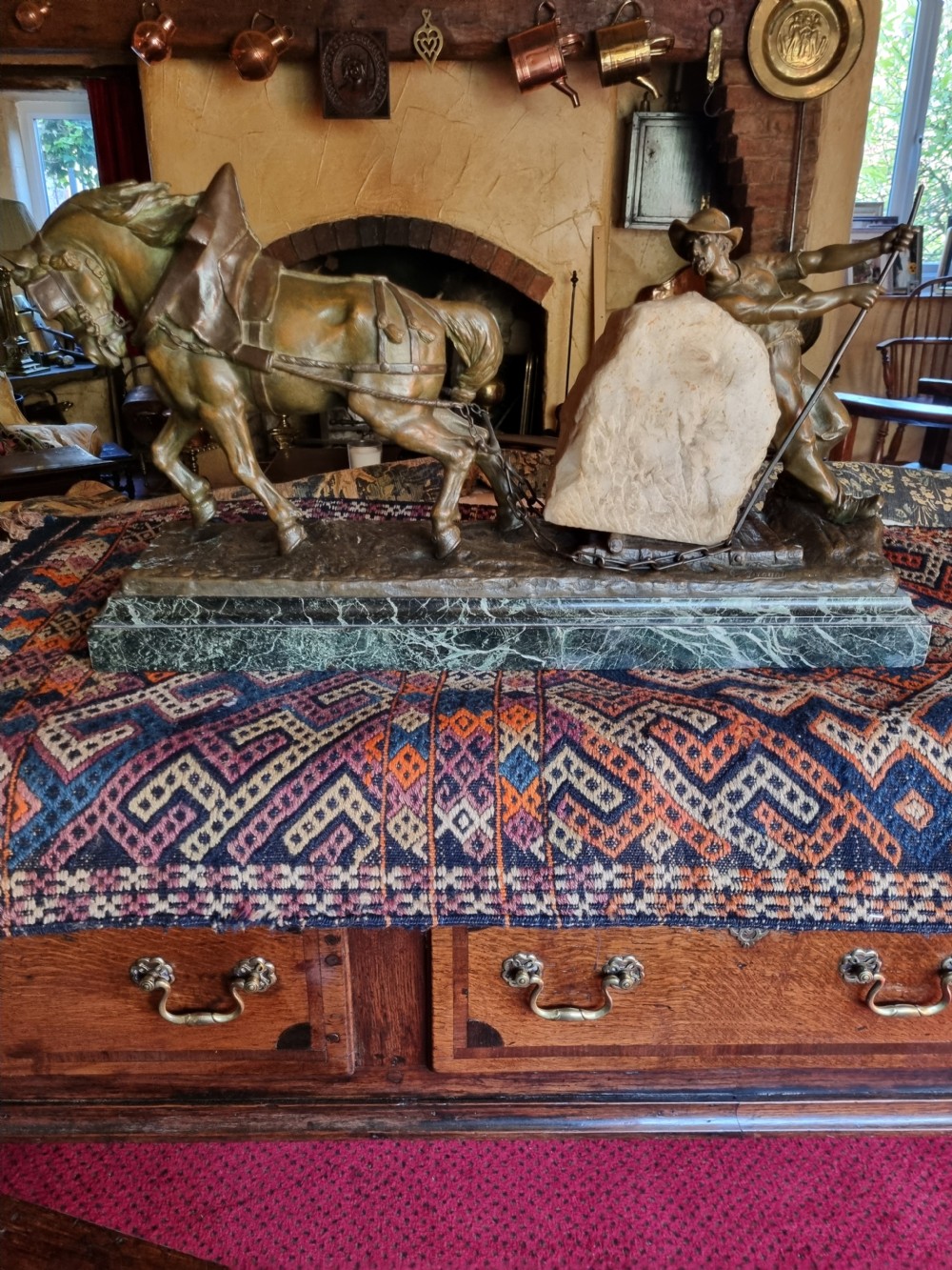 A late 19th-century patinated bronze sculpture depicting a harnessed horse pulling a stone quarry sled alongside a worker, mounted on a green marble base. View VII