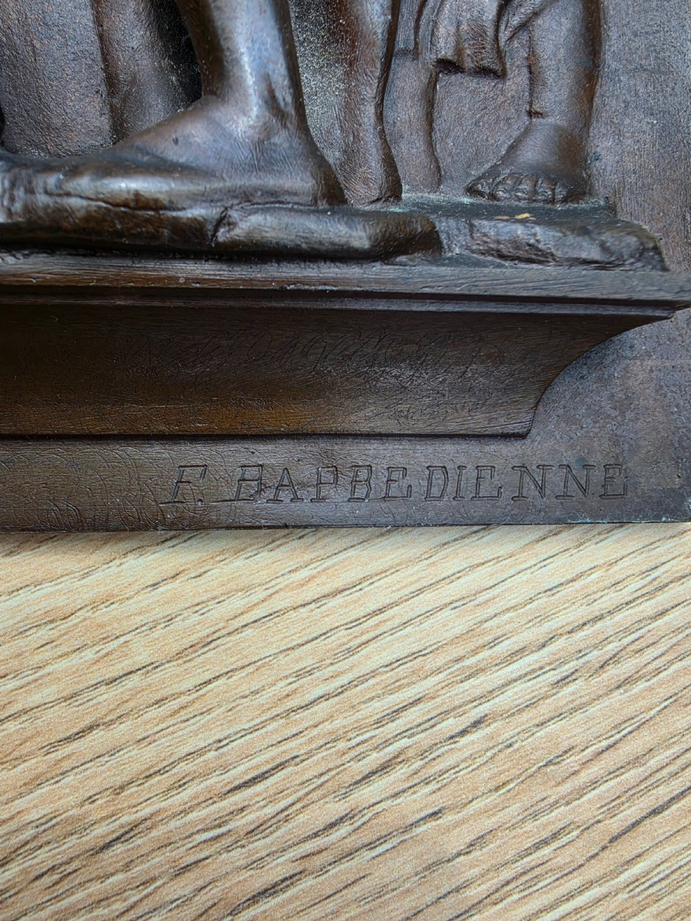 A square dark brown bronze relief plaque featuring cast figures playing musical instruments and dancing, signed F. Barbedienne at the lower right. View II