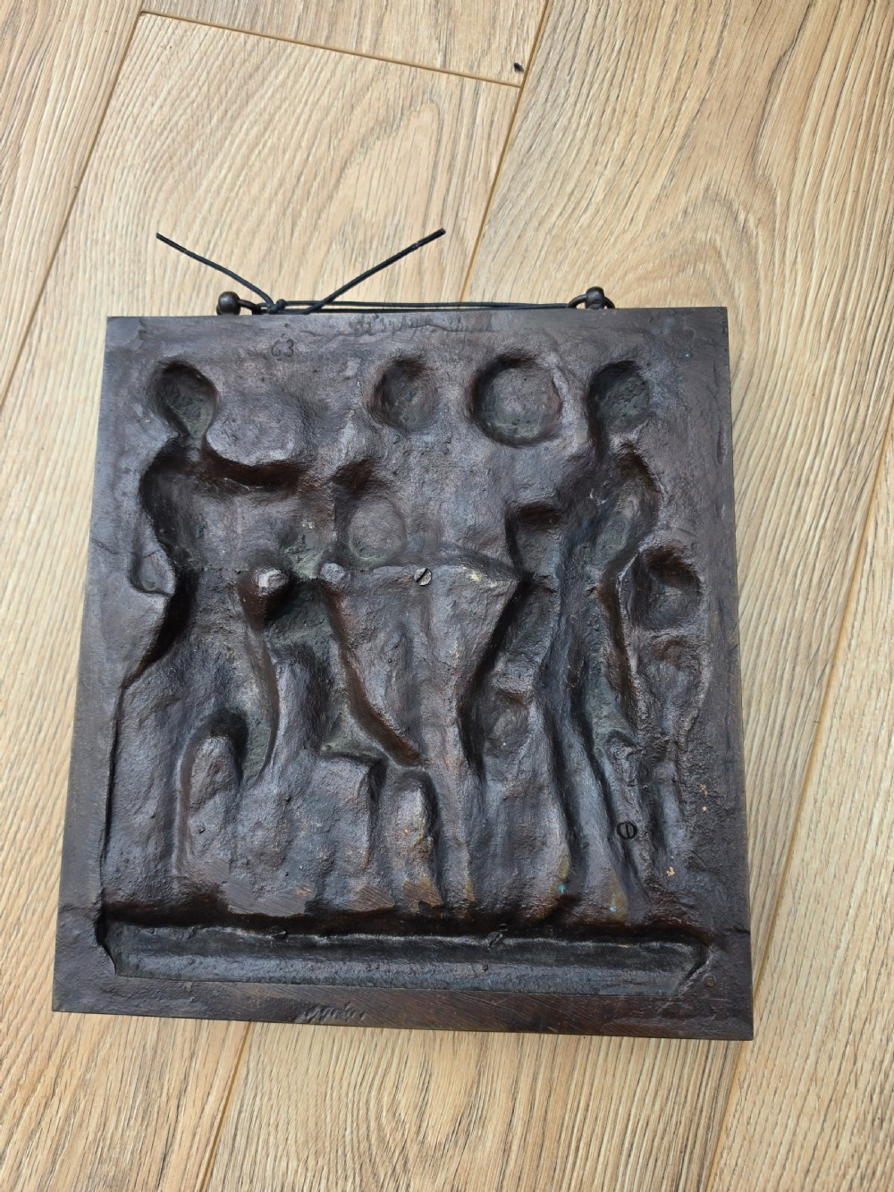 A square dark brown bronze relief plaque featuring cast figures playing musical instruments and dancing, signed F. Barbedienne at the lower right. View VI