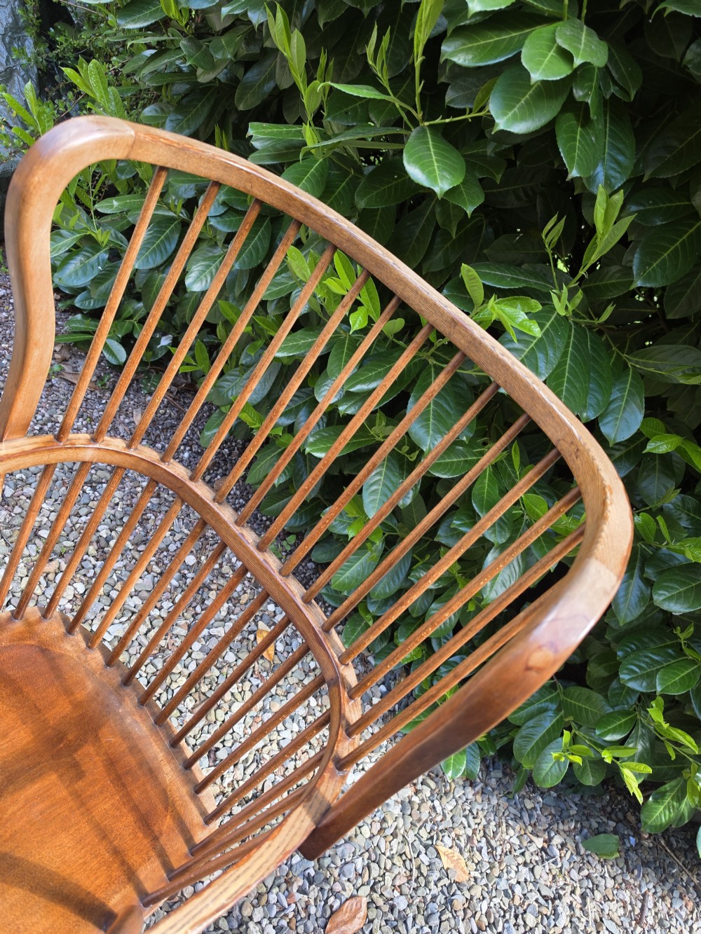 A late nineteenth-century ash and elm winged Windsor armchair featuring vertical back spindles, swept armrests, a shaped saddle seat, and turned wooden legs. View IV