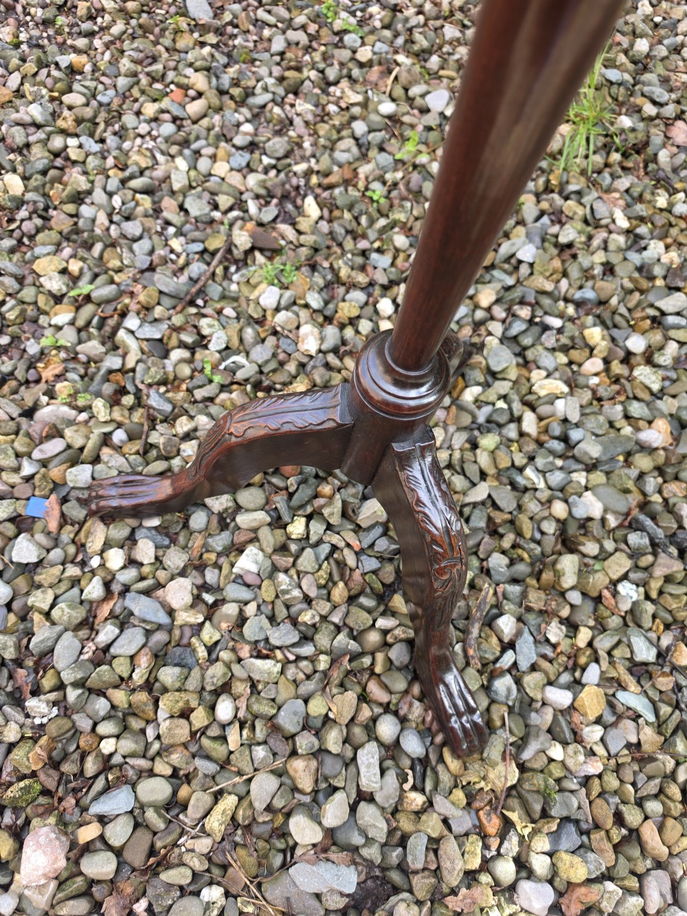 An Edwardian dark mahogany torchere stand featuring a carved piecrust top, turned stem, and tripod cabriole legs. View III