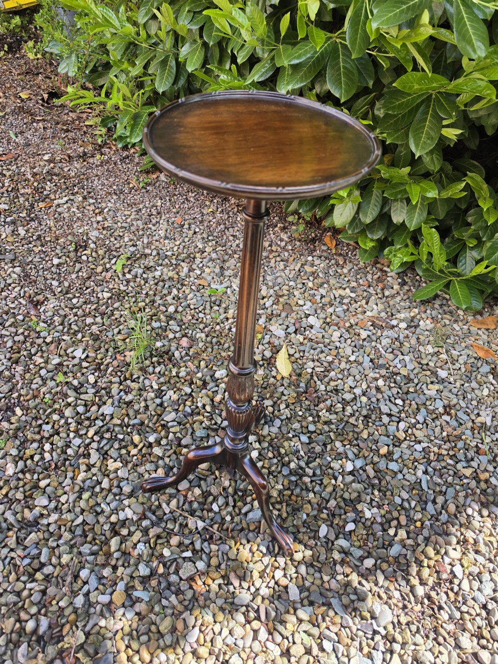 A tall mahogany plant stand with a circular dished top, reeded central column, and tripod cabriole legs ending in claw and ball feet. View V
