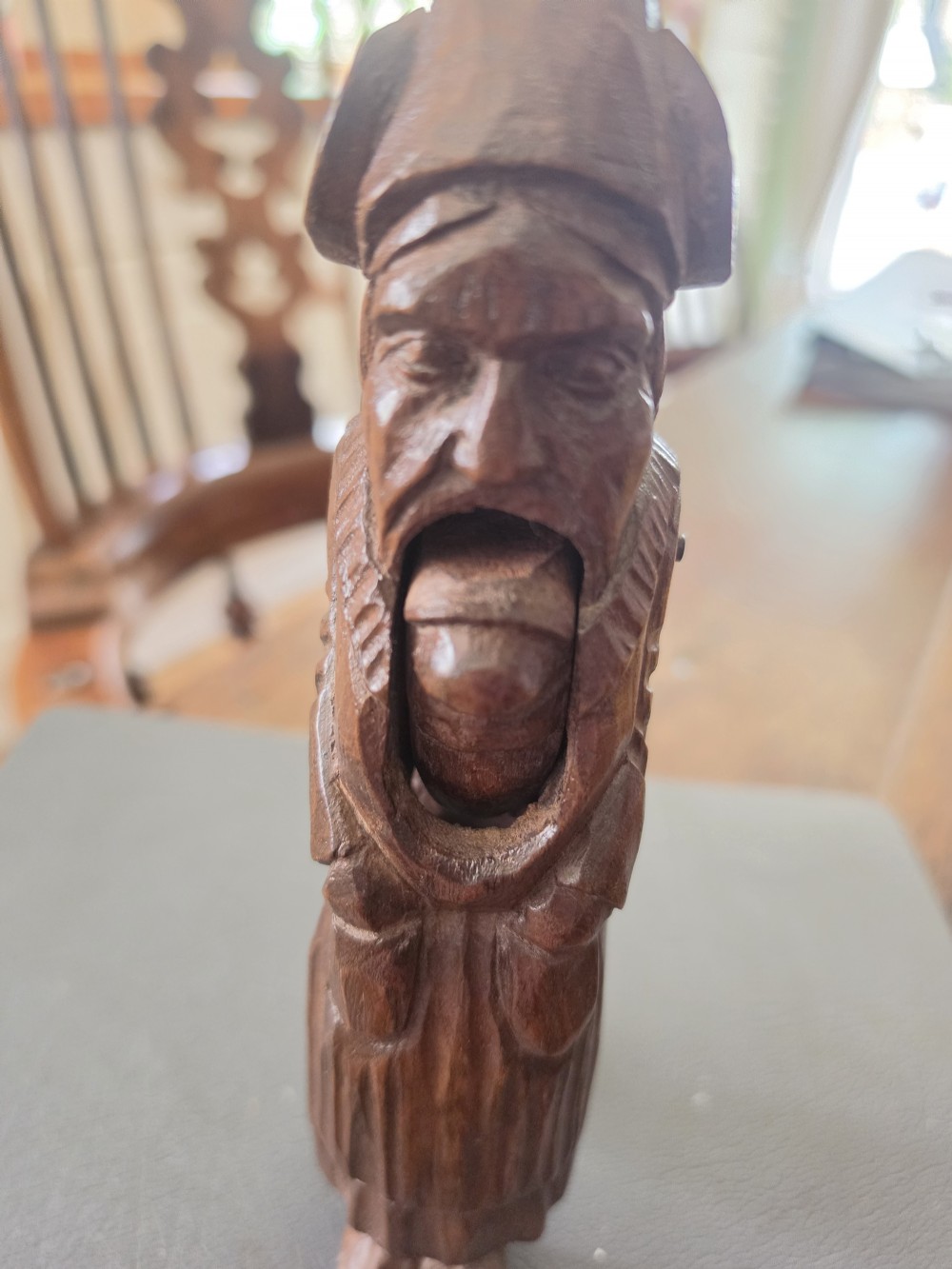 A hand-carved dark oak nutcracker depicting a standing human figure with an open mouth mechanism. View III