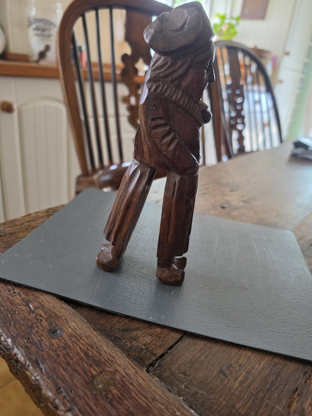 A hand-carved dark oak nutcracker depicting a standing human figure with an open mouth mechanism. View V