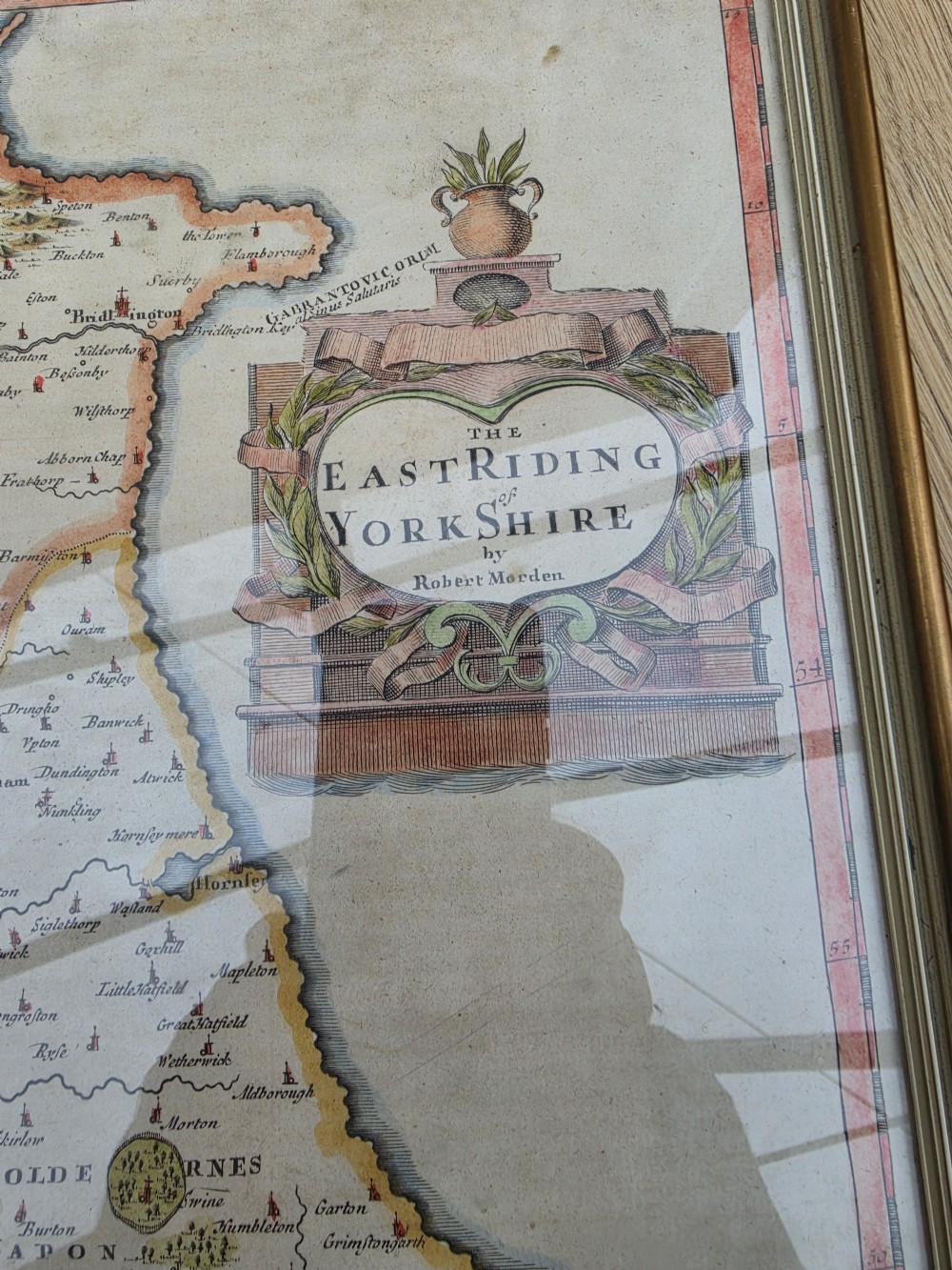 A framed 17th-century hand-coloured engraved map of the East Riding of Yorkshire featuring a decorative cartouche and thin gold border. View II