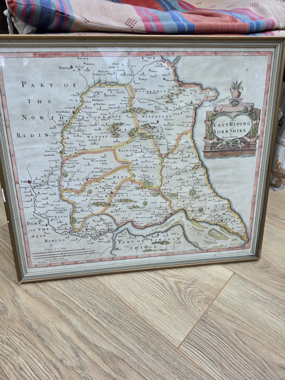 A framed 17th-century hand-coloured engraved map of the East Riding of Yorkshire featuring a decorative cartouche and thin gold border. View III