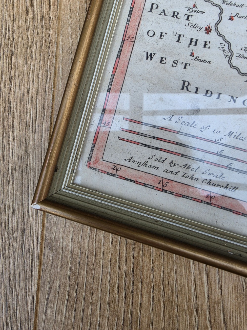 A framed 17th-century hand-coloured engraved map of the East Riding of Yorkshire featuring a decorative cartouche and thin gold border. View IV