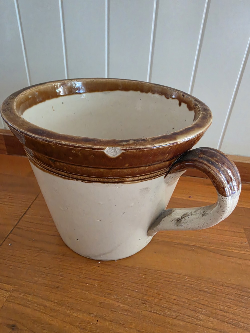 A Victorian cream stoneware dairy crock featuring a brown glazed rim and black transfer-printed Maypole Dairy lettering and illustration. View III