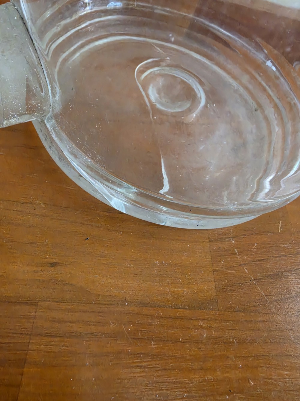 A large clear glass Schweppes fruit juice dispenser featuring printed lettering, a pointed finial lid, and a metal tap at the base. View III