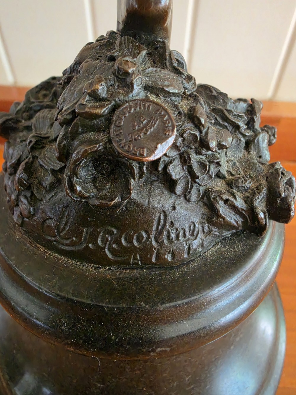 A dark patinated bronze figure depicting a female dancer in mid-motion with raised arms, standing balanced on a circular base. View III