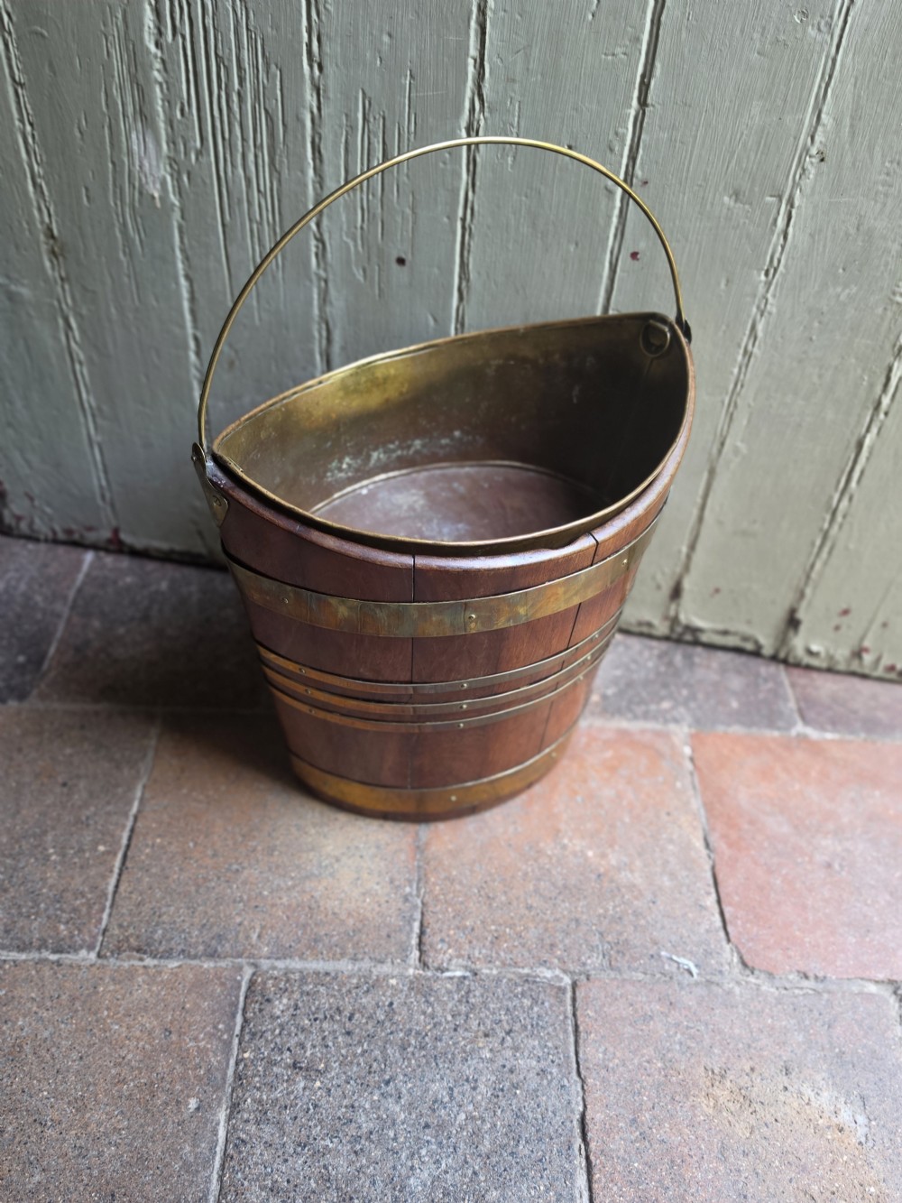 An 18th-century staved mahogany plate bucket featuring brass banding, a removable brass lining, and a brass swing handle. View II