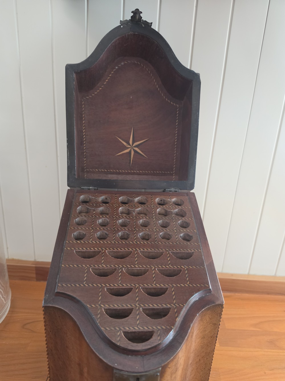 A Georgian mahogany knife box featuring a sloped lid, serpentine front, brass lock plate, ring handle, and edge stringing. View II