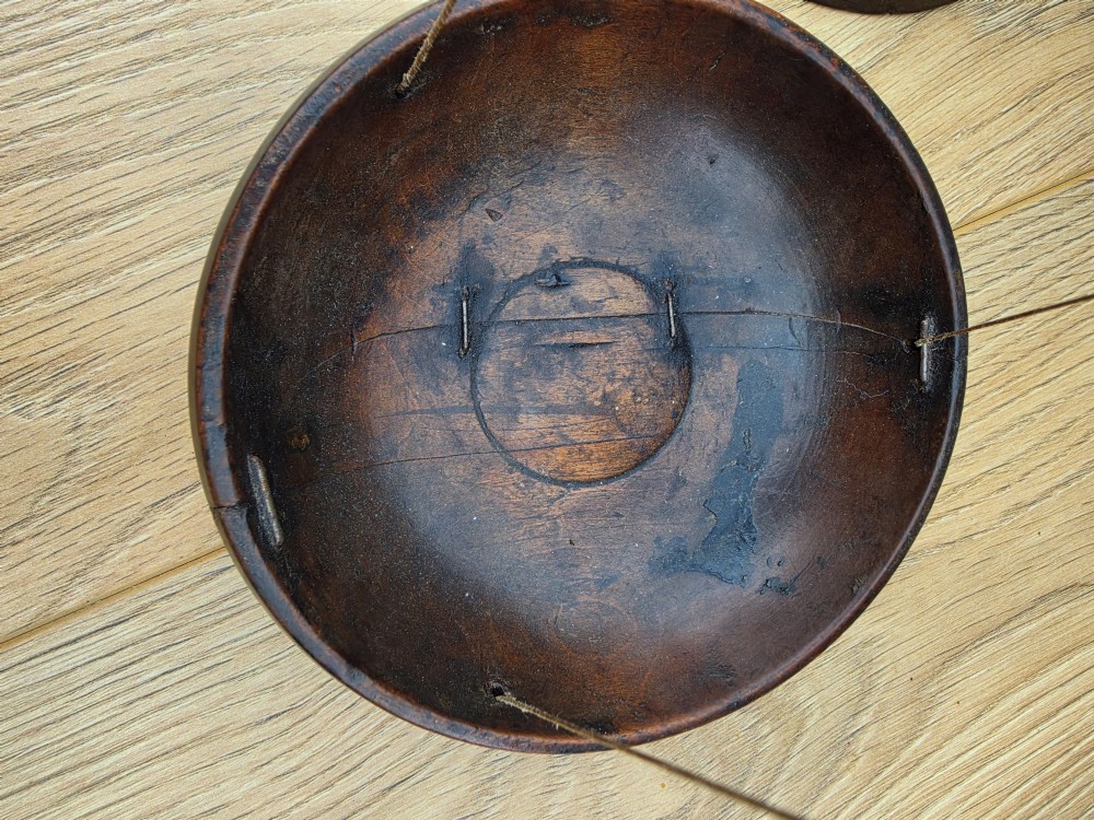A 19th-century turned dark wood treen balance scale set with a central column, horizontal crossbar, and two suspended wooden pans. View II