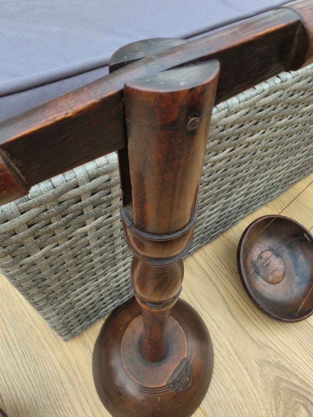A 19th-century turned dark wood treen balance scale set with a central column, horizontal crossbar, and two suspended wooden pans. View VI
