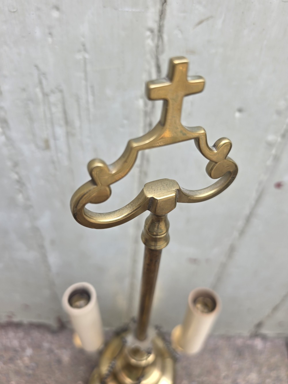 A 19th-century brass student lamp with a circular stepped base, central turned stem with loop handle, three candle sleeves, and miniature brass tools suspended from chains. View IV