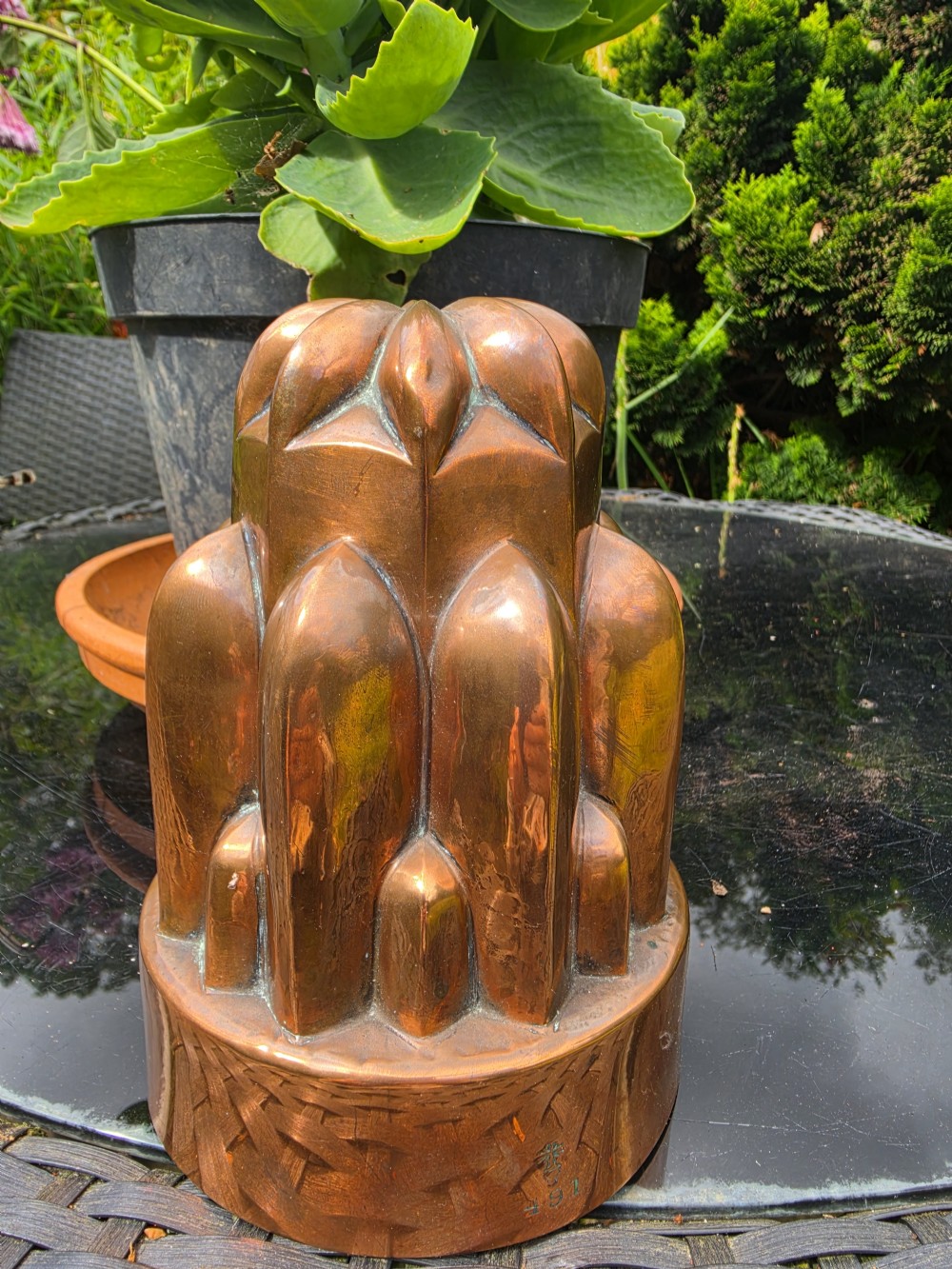 A tiered Victorian copper jelly mould featuring geometric fluted and arched column details. View V