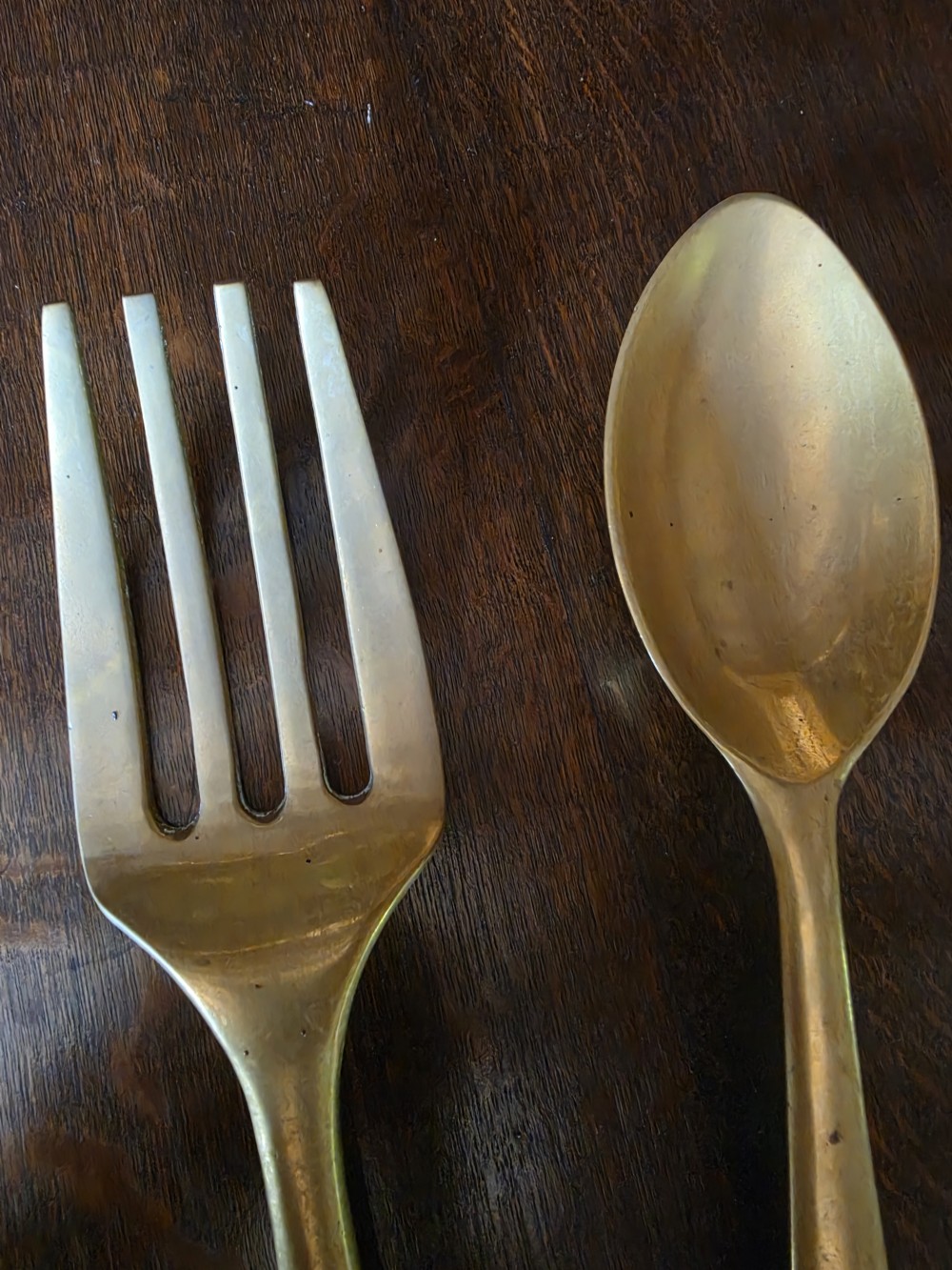 A pair of vintage brass wall plaques shaped as a large spoon and fork with pre-drilled mounting holes at the top of the handles. View III