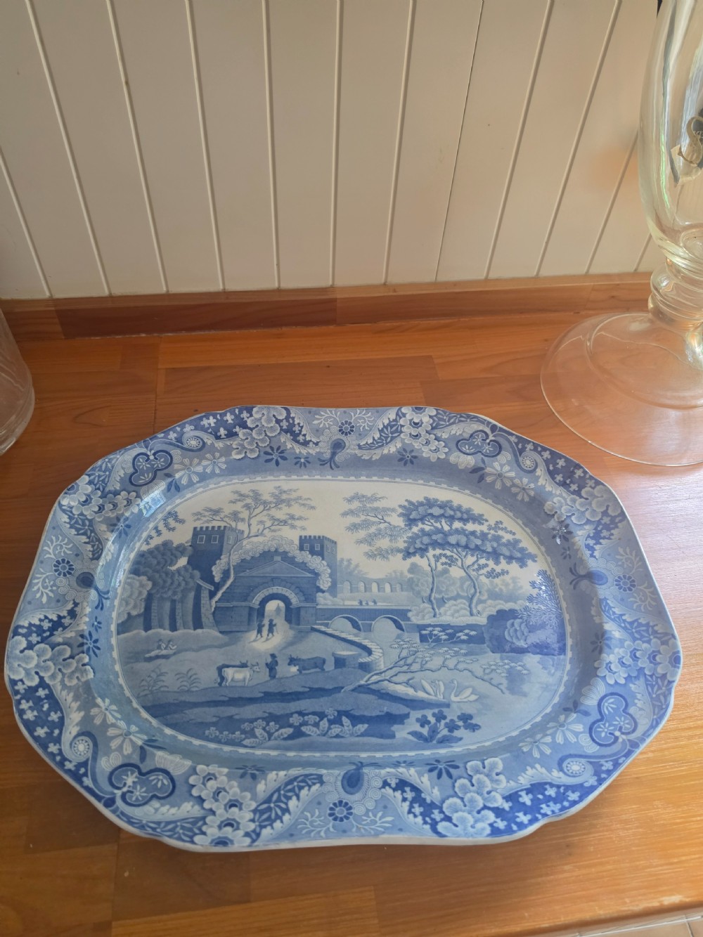 An early 19th-century octagonal Spode blue and white transferware meat platter featuring a detailed architectural landscape and floral border.
