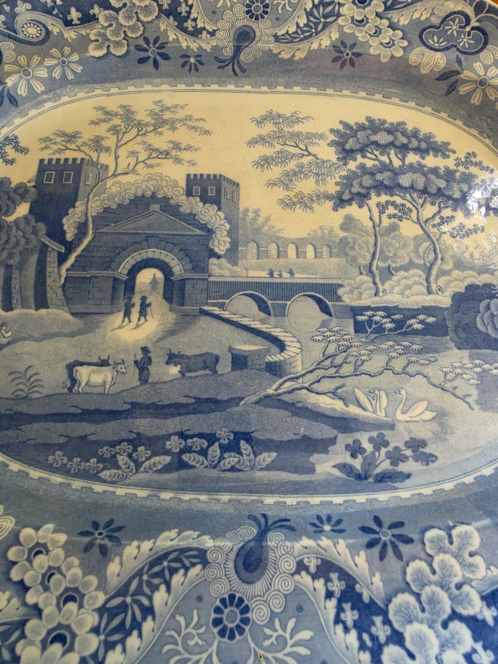 An early 19th-century octagonal Spode blue and white transferware meat platter featuring a detailed architectural landscape and floral border. View III