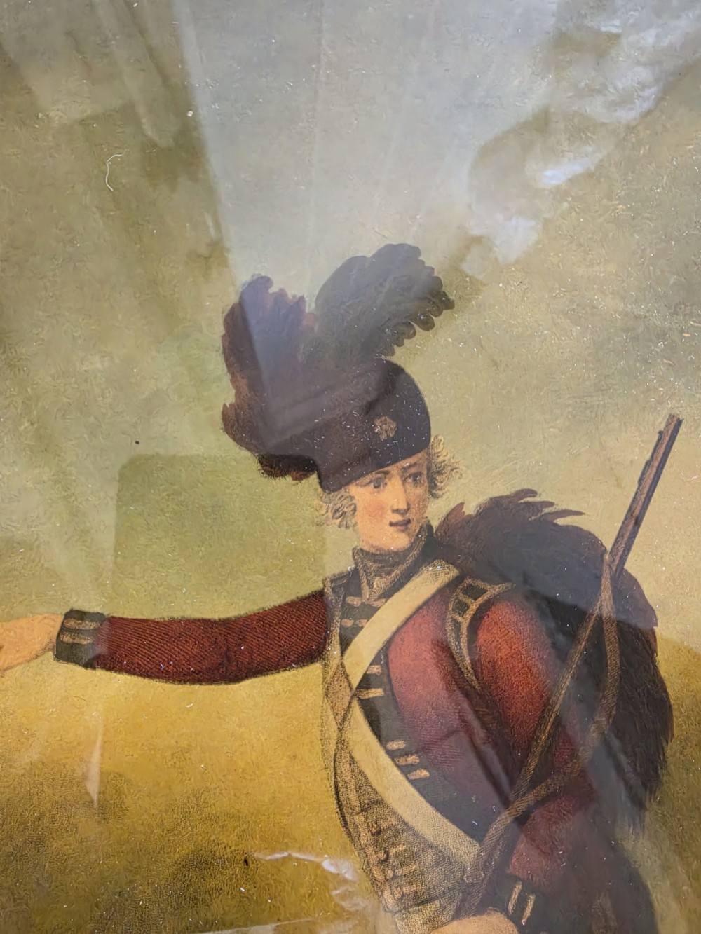 A 19th-century reverse glass picture depicting a Light Infantryman in a red coat, framed within a birds eye maple timber frame with a gilded inner slip. View II