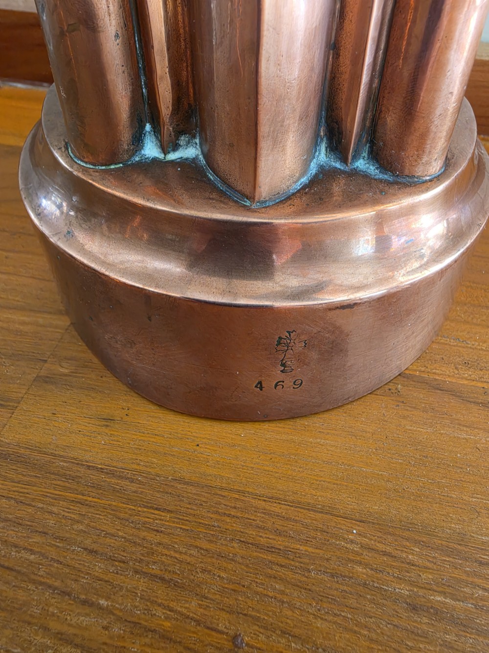 A large 19th-century copper jelly mould featuring a tiered architectural design with vertical fluted arches and a patinated finish. View II
