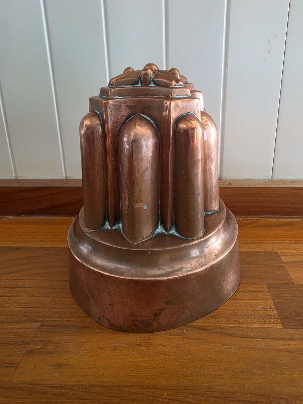 A large 19th-century copper jelly mould featuring a tiered architectural design with vertical fluted arches and a patinated finish. View III