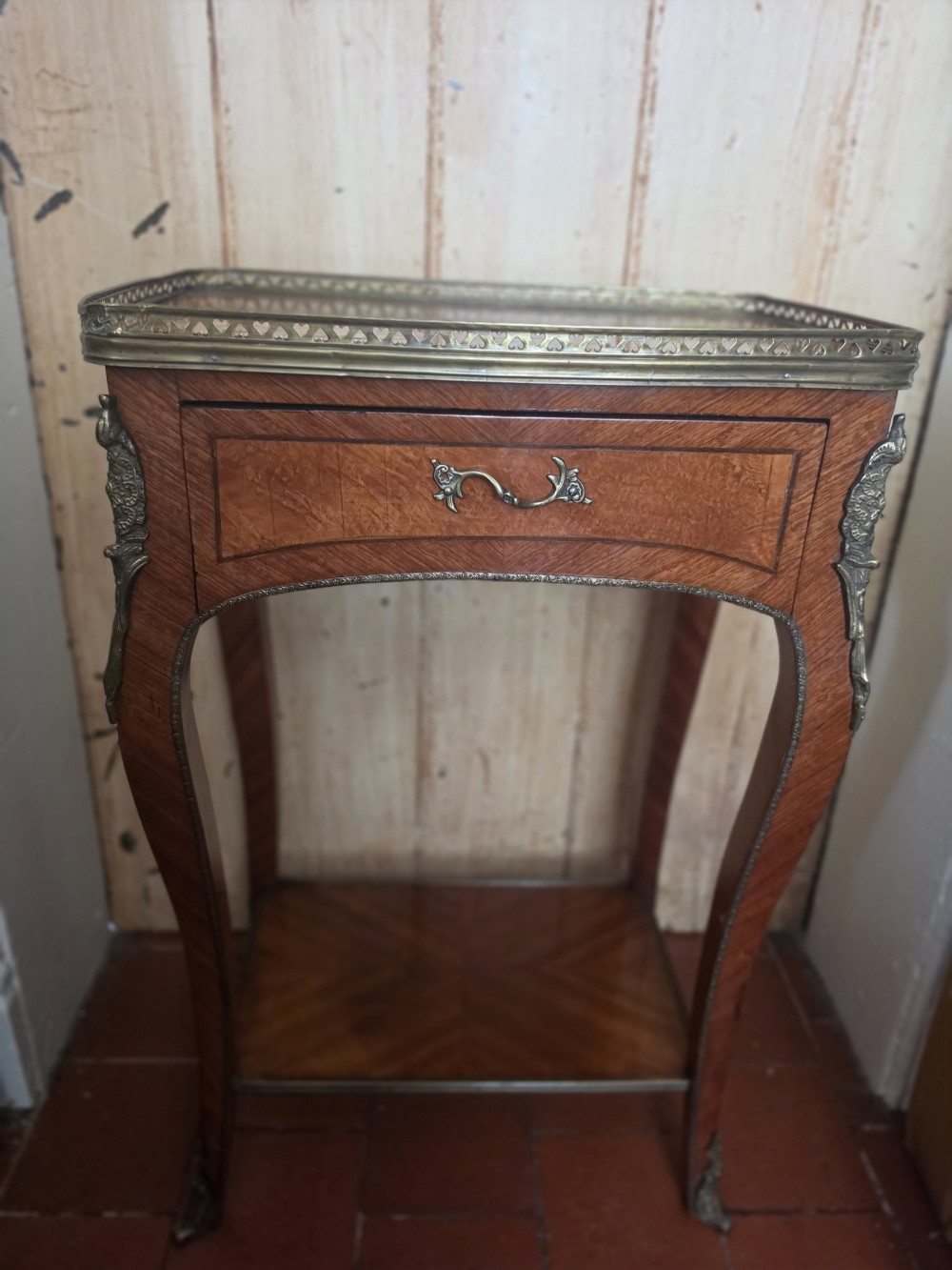 A 19th-century French style marquetry inlaid side table featuring a pierced brass gallery rim, single drawer, lower tier shelf, and cabriole legs with brass mounts. View V