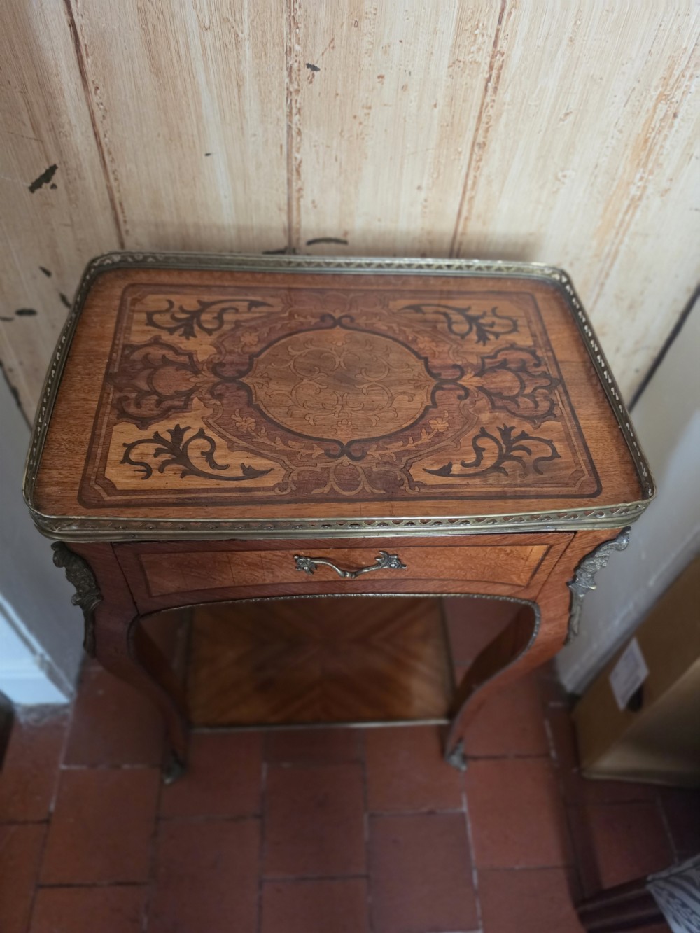 A 19th-century French style marquetry inlaid side table featuring a pierced brass gallery rim, single drawer, lower tier shelf, and cabriole legs with brass mounts. View VII