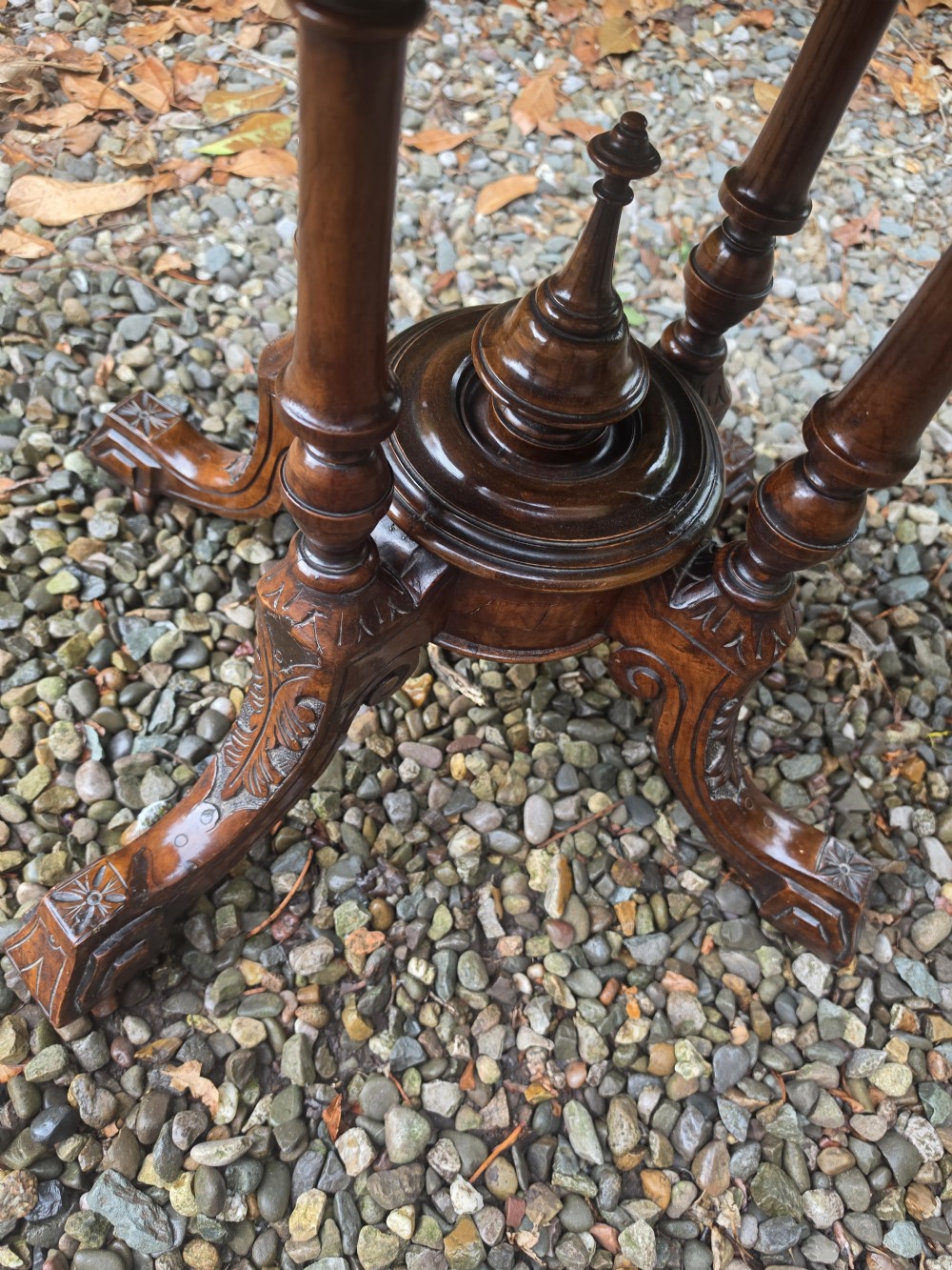 An oval 19th-century burr walnut centre table featuring floral marquetry inlay, supported by turned central columns and four carved legs. View V