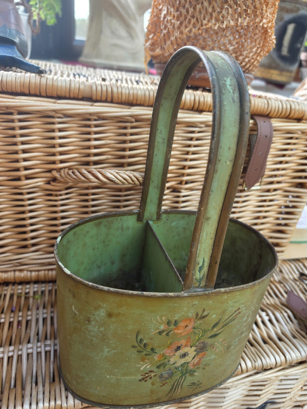 An antique sage green painted metal two-bottle wine carrier with a central divider, high handle, and hand-painted floral bouquet. View II