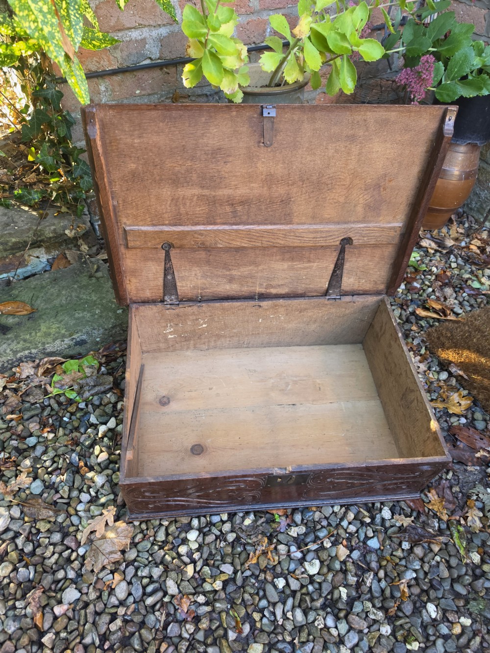 A rectangular dark oak bible box featuring carved scroll detailing on the front panel and a central iron keyplate. View II