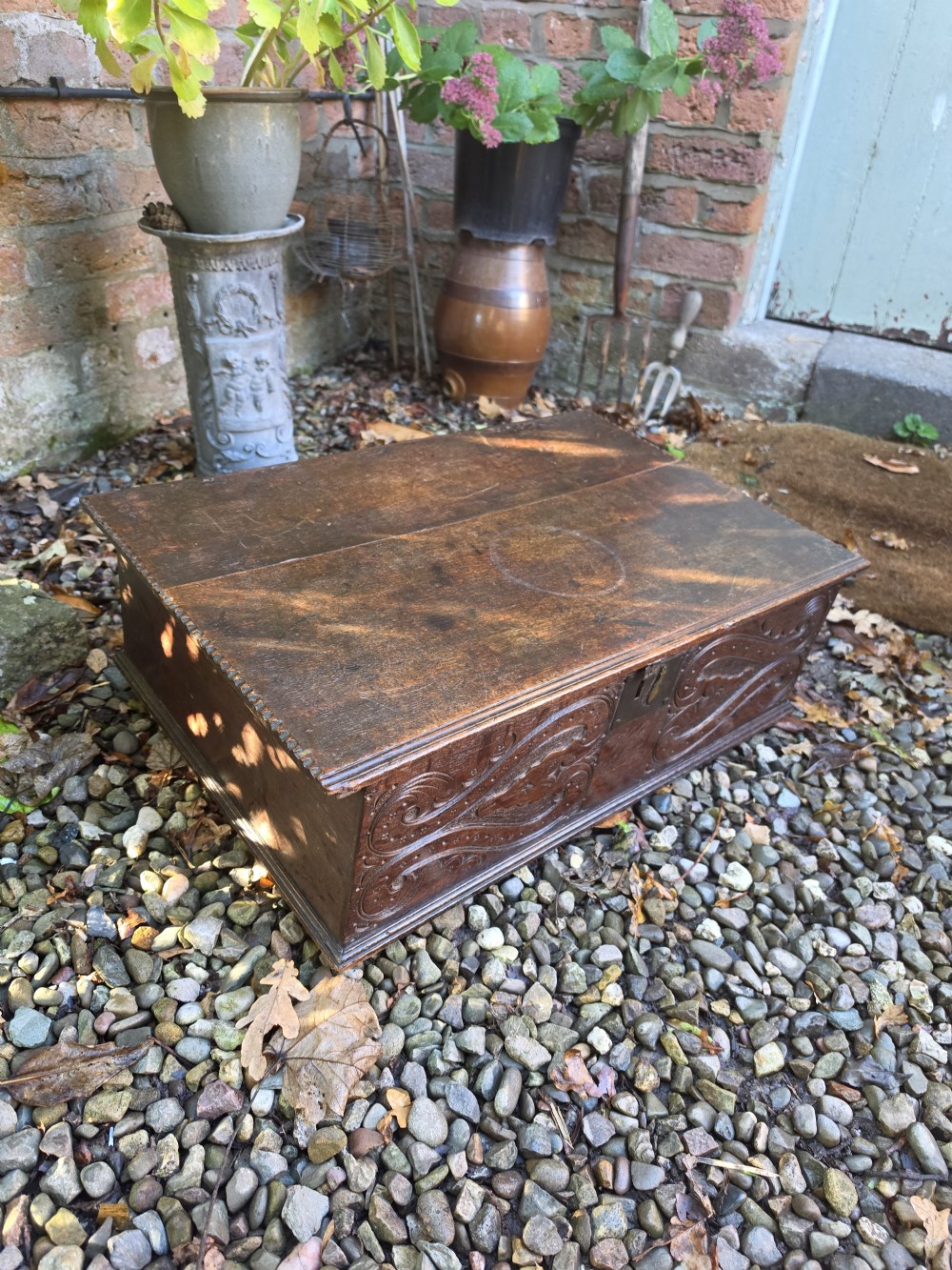 A rectangular dark oak bible box featuring carved scroll detailing on the front panel and a central iron keyplate. View V