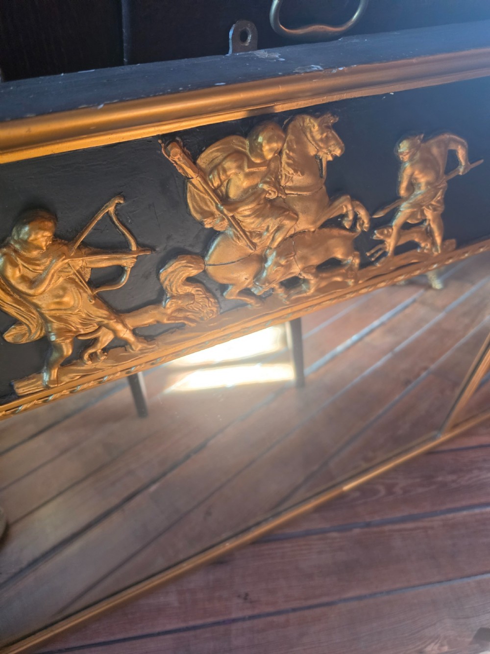 A large 19th-century Regency triple-plate overmantel mirror featuring a black frieze decorated with gold classical figures and fluted side columns. View II