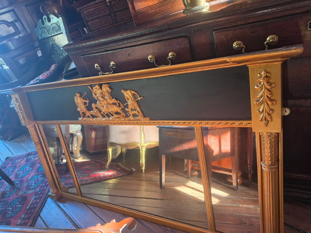 A large 19th-century Regency triple-plate overmantel mirror featuring a black frieze decorated with gold classical figures and fluted side columns. View III
