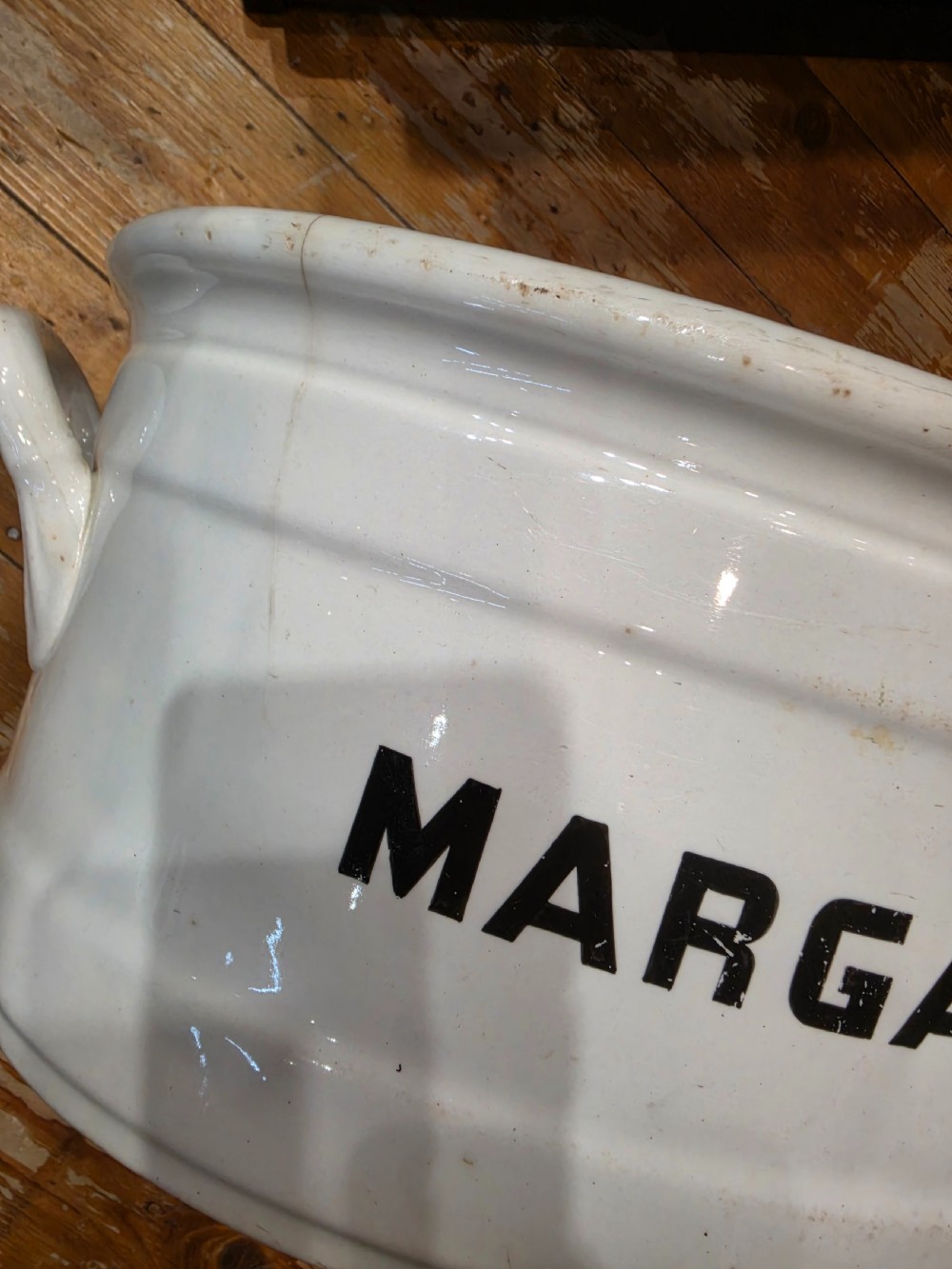 A white glazed ceramic oval tub with twin side handles, featuring bold black capital letters reading MARGARINE across the front. View III