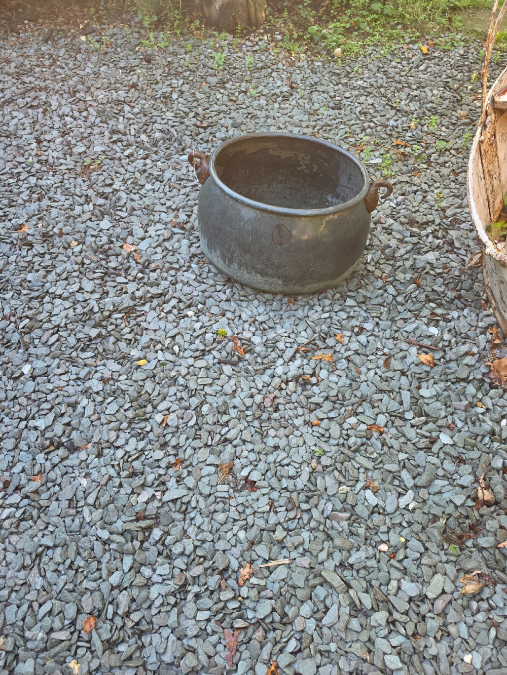A large 19th-century copper cauldron with a rounded body, rolled rim, iron handles, and a verdigris patina. View III